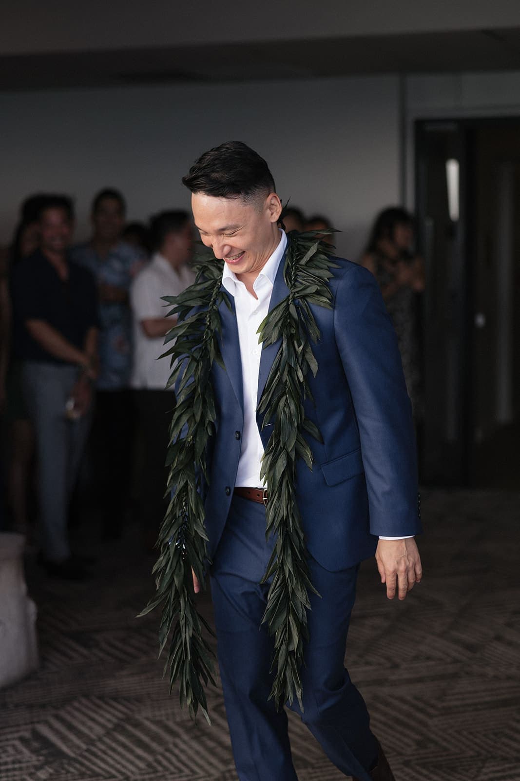 Groom laughing during the grand entrance at an Oahu reception